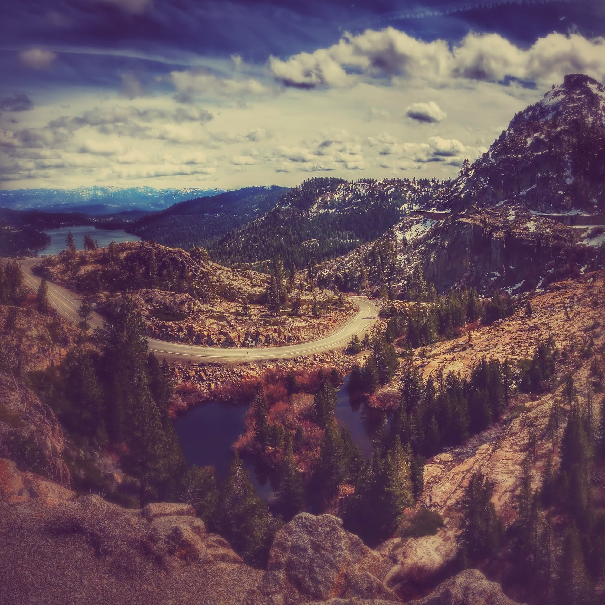Scenic view of a mountainous landscape with a winding road and lakes at Donner Pass, CA, In Fall