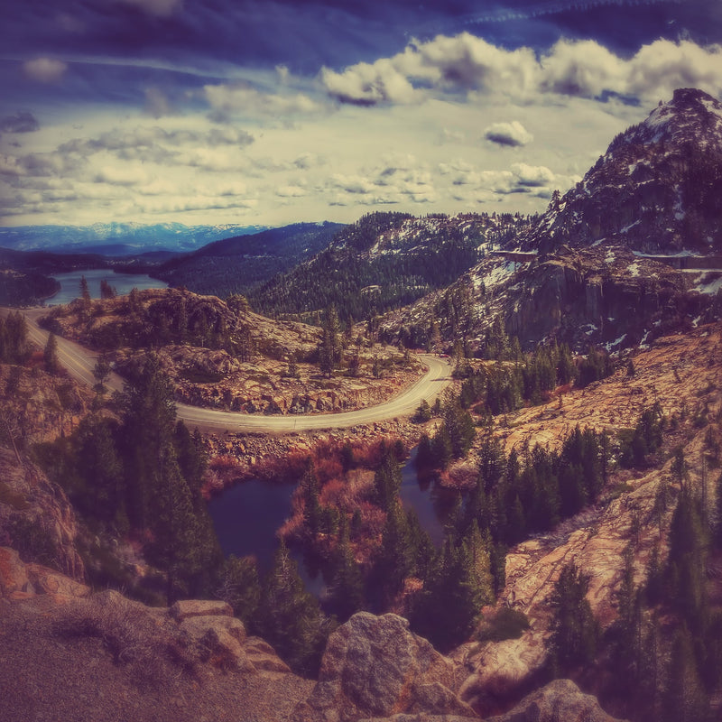 Scenic view of a mountainous landscape with a winding road and lakes at Donner Pass, CA, In Fall