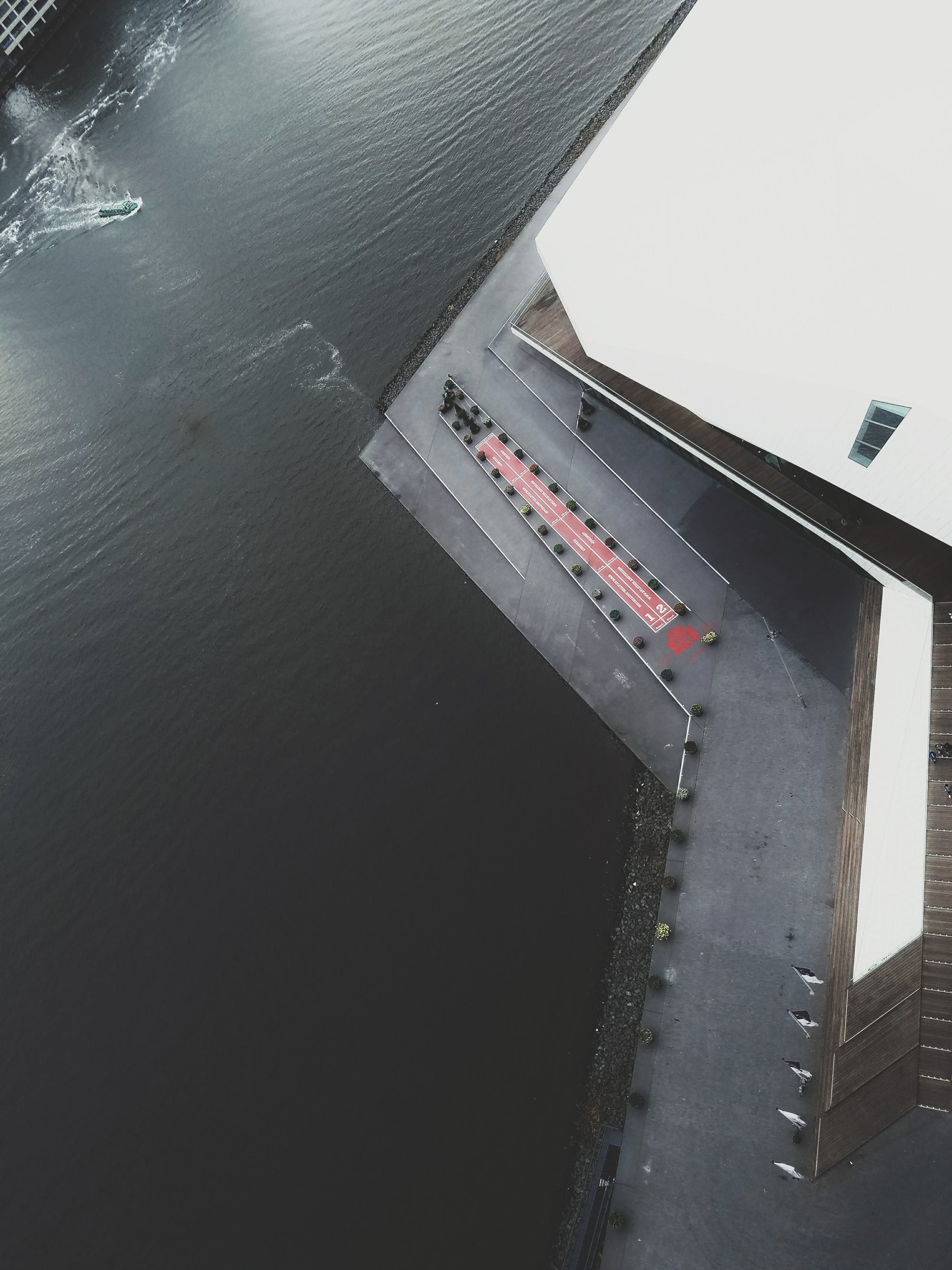 Aerial view of a dock with a small boat and a building in the background at A'DAM Lookout, Amsterdam, Netherlands
