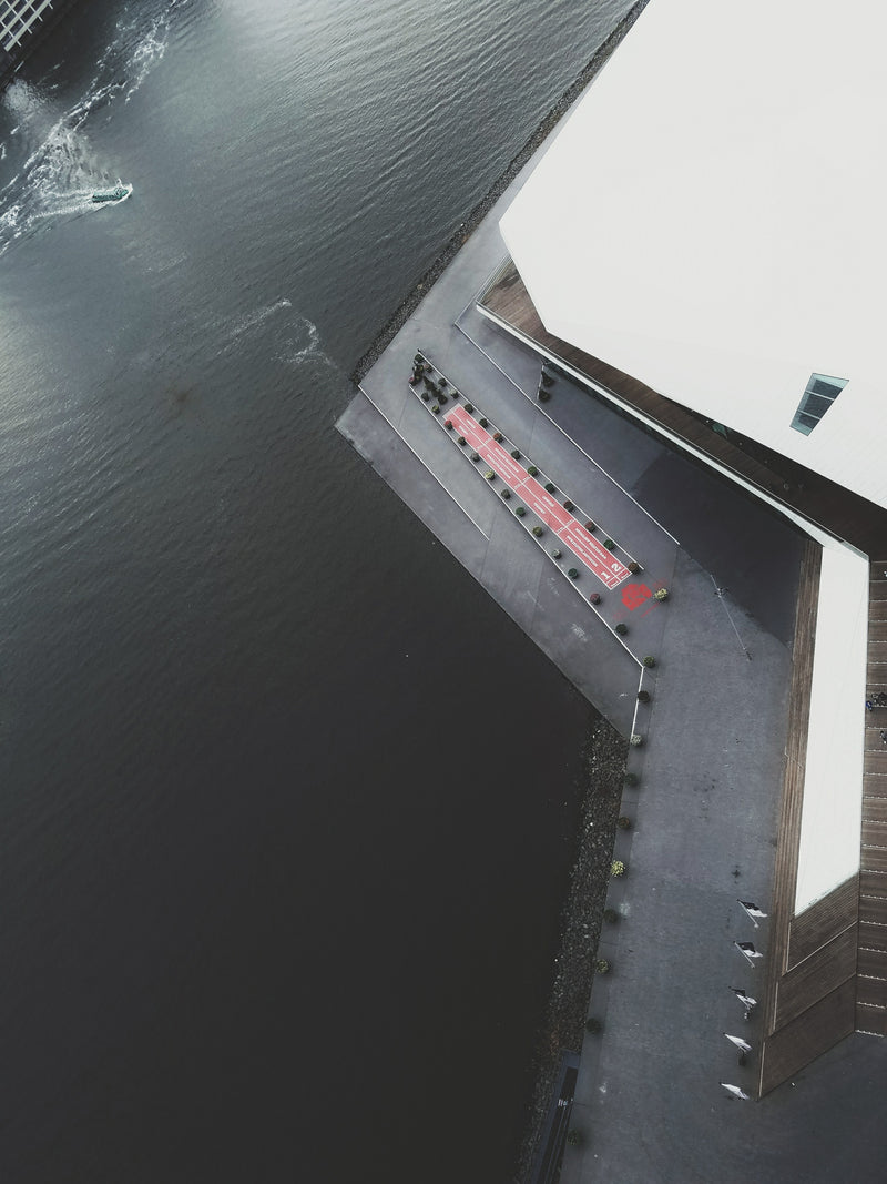 Aerial view of a dock with a small boat and a building in the background at A'DAM Lookout, Amsterdam, Netherlands