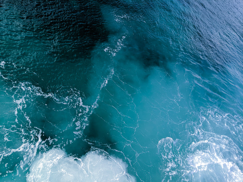 Close-up of ocean waves with white foam on a blue background in La Isla De Culebra, Puerto Rico