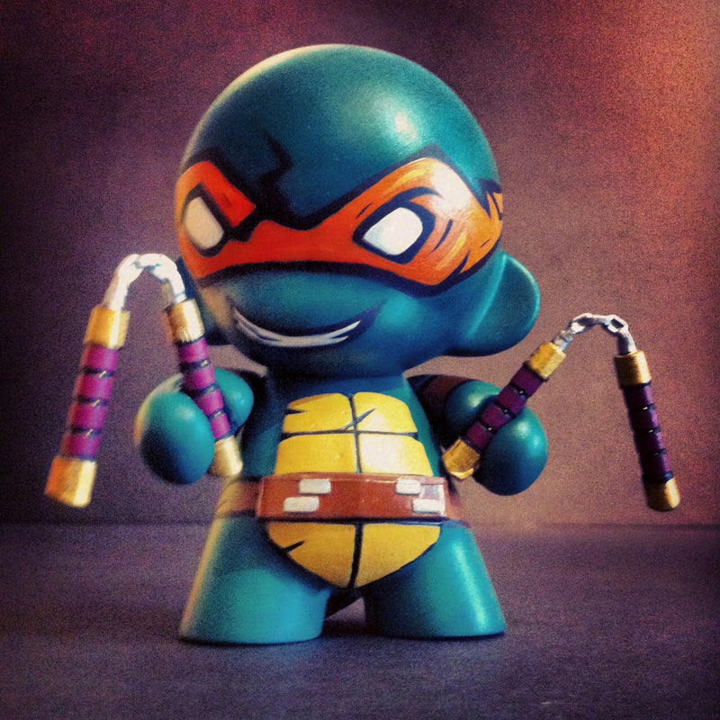 Custom-painted Michelangelo vinyl figure from the Teenage Mutant Ninja Turtles. The base figure is a Kidrobot DIY MUNNY